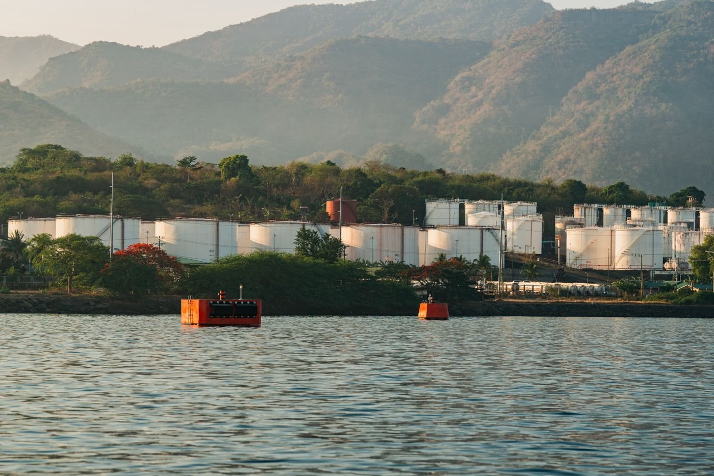 Bulk storage tanks beside deep water, ready for lower-carbon fuels